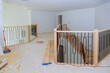 As part of construction process new residence wooden railing is being assembled and installed
