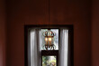 Antique pendant light with window in background.