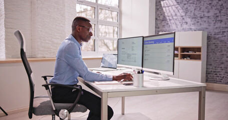 Poster - young businessman looking at invoice while doing online banking