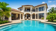 © Prasanth - Beautiful home exterior and large swimming pool on sunny day with blue sky.