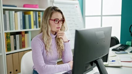 Poster - Young blonde woman student having video call with winner expression at classroom