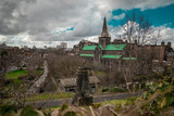 Fototapeta Natura - Big Glasgow cathedral on a spring day looking from above at the location of Glasgow Necropolis. Cloudy day and a big victorian cathedral church