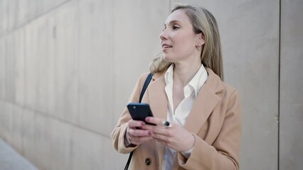 Sticker - Young blonde woman smiling confident using smartphone at street