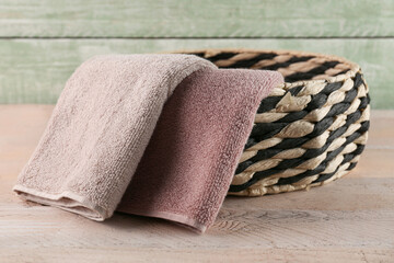Wall Mural - Wicker basket with soft towels on wooden table