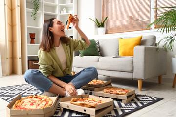 Canvas Print - beautiful woman with boxes of tasty pizza sitting on floor at home