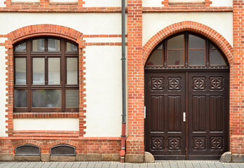 Wall Mural - View of brick building with wooden door and window