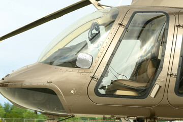 Wall Mural - New modern helicopter with leather seats in field