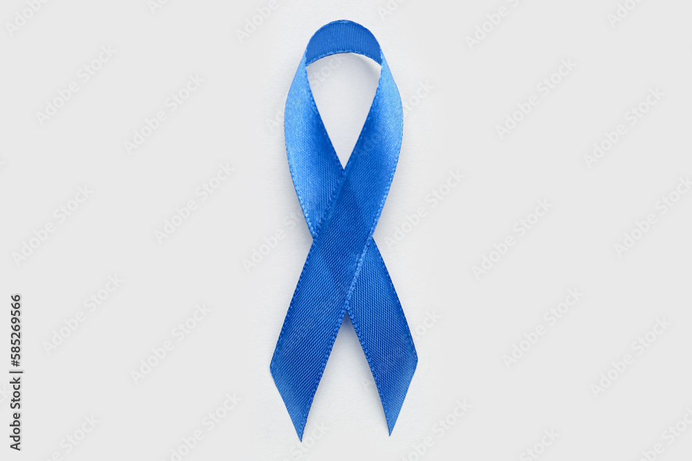 Blue awareness ribbon on light background. Prostate cancer concept