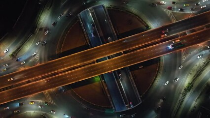 Poster - Expressway top view, Road traffic an important infrastructure, car traffic transportation above intersection road in city night sky aerial view cityscape of advanced innovation, financial technology	