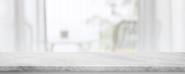 Empty white marble stone table top and blurred living room at home interior with window curtain background. - can used for display or montage your products.