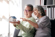 © Katcha - Senior couple holding house model for buying in life retirement