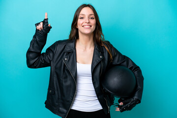 Wall Mural - Young caucasian woman with a motorcycle helmet isolated on blue background pointing up a great idea