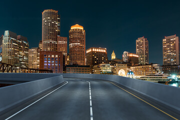 Empty urban asphalt road exterior with city buildings background. New modern highway concrete construction. Concept of way to success. Transportation logistic industry fast delivery. Boston. USA.