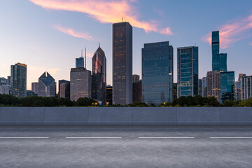 Empty urban asphalt road exterior with city buildings background. New modern highway concrete construction. Concept of way to success. Transportation logistic industry fast delivery. Chicago. USA.