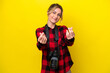 Uruguayan photographer woman isolated on yellow background making money gesture