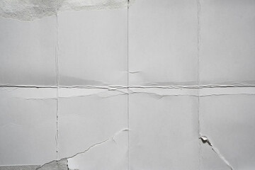 Wall Mural - White damaged paper background folded into eight parts