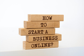 Wall Mural - Wooden blocks with words 'How to Start a Business Online?'.