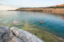 A Male Tourist Relaxes In The Water Of The Dead Sea
