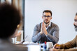 © Dusan Petkovic - A manager is sitting at the boardroom on a meeting with team and listening to proposals for new project.