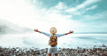 Happy Man With Arms Outstretched Standing Outside - Delightful Traveler With Backpack Enjoying Summer Trip - Successful People, Well Being And Traveling Lifestyle Concept