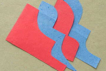 Wall Mural - overlapping, cut blue and red paper with elegant profiles