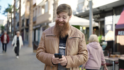 Sticker - Young redhead man smiling confident using smartphone at coffee shop terrace