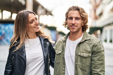 Sticker - Man and woman couple smiling confident standing together at street