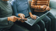 © Phushutter - My device of three people as mother, daughter and friends watching social media news, using laptop computer, tablet pc and mobile cell phone on sofa.