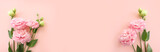 Top view image of delicate pink flowers over pastel background