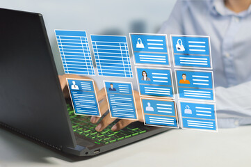 hr officer working on a laptop with employee data to manage payroll, holiday leave and recruit more 