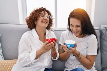 Poster - Two women mother and daughter drinking coffee at home