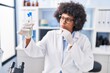 © Krakenimages.com - African american woman scientist holding test tubes at laboratory