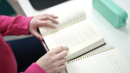 Poster - Young blonde woman student reading book sitting on table at library university