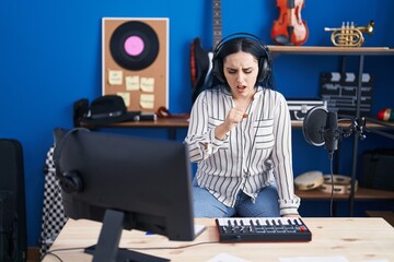 Sticker - Young modern girl with blue hair at music studio wearing headphones feeling unwell and coughing as symptom for cold or bronchitis. health care concept.