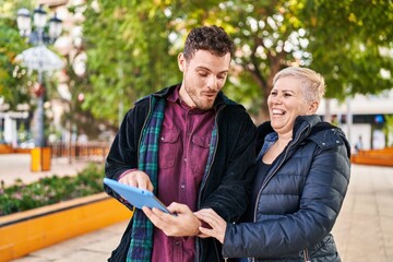 Poster - Mother and son smiling confident using touchpad at park