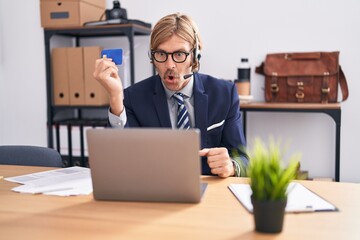 Sticker - Caucasian man with mustache working at the office doing online shopping scared and amazed with open mouth for surprise, disbelief face