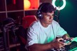© Krakenimages.com - Young hispanic man streamer playing video game using joystick at gaming room