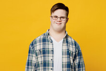 Young Smiling Fun Cheerful Happy Positive Man With Down Syndrome Wearing Glasses Blue Casual Clothes Looking Camera Isolated On Pastel Plain Yellow Color Background. Genetic Disease World Day Concept.