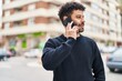 © Krakenimages.com - Young arab man smiling confident talking on the smartphone at street