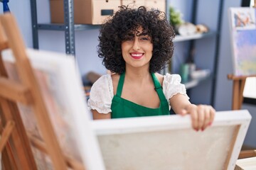 Sticker - Young middle east woman smiling confident holding draw at art studio