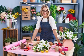 Poster - Young blonde woman florist smiling confident standing at florist shop