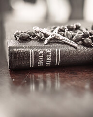 Catholic rosary and crucifix laying on leather bound holy Bible close up, Christian, Christianity, faith and grace of Jesus Christ