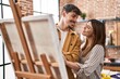 © Krakenimages.com - Mand and woman artist couple smiling confident drawing at art studio