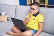 © Krakenimages.com - Adorable hispanic boy having video call communicate with sign deaf language at home