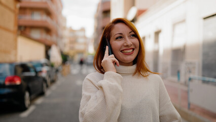 Poster - Young redhead woman smiling confident talking on the smartphone at street