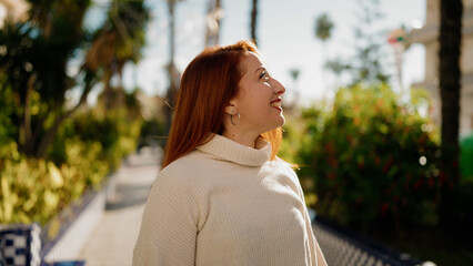 Canvas Print - Young redhead woman smiling confident walking at park