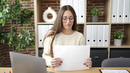 Sticker - Young beautiful hispanic woman business worker using laptop reading document at office