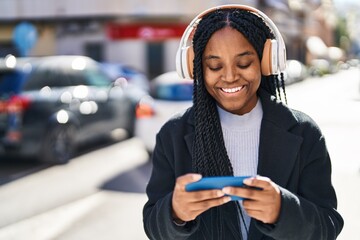 Poster - African american woman smiling confident playing video game at street