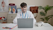 © Krakenimages.com - Young hispanic man doctor using laptop working at clinic