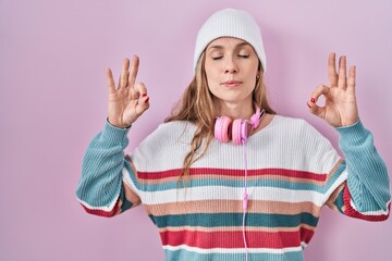 Sticker - Young blonde woman standing over pink background relax and smiling with eyes closed doing meditation gesture with fingers. yoga concept.